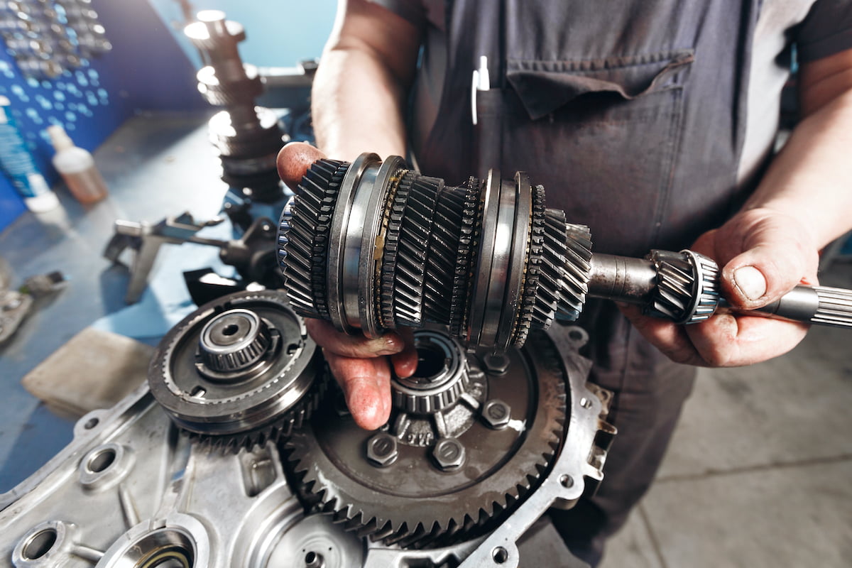 Auto Mechanic working on Gearbox Transmission